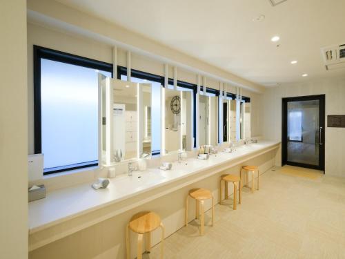 a bathroom with a row of sinks and mirrors at ALA HOTEL KYOTO in Kyoto
