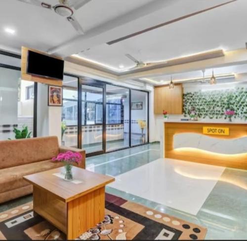 a living room with a couch and a table at Hotel krishna in Mānsa