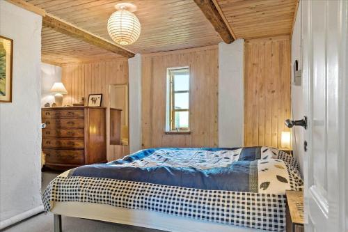 a bedroom with a bed and a wooden ceiling at 20206-Samso-Haardmark-Mark-7 in Kolby Kås