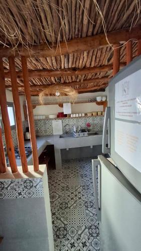 a room with a bench and a table in a building at L'auberge des Vagues in Sidi Kaouki