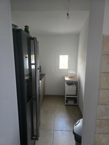 a bathroom with a refrigerator and a tile floor at villa gambotti in Morta