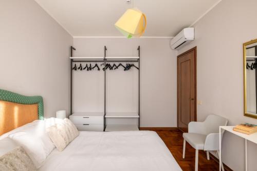 a small bedroom with a bed and a chair at Trilocale Ferruccio in Baveno
