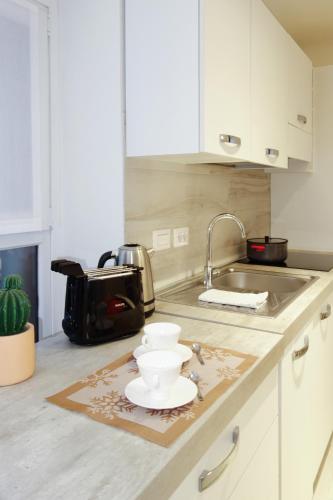 a kitchen counter with a sink and a bowl on it at Ca di baragett in Mandello del Lario