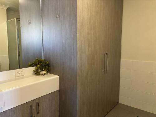 a bathroom with a sink and a mirror at Courtyard apartment in Perth