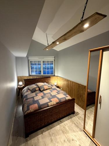 a bedroom with a bed and a window at Les Loutrons in Cornimont
