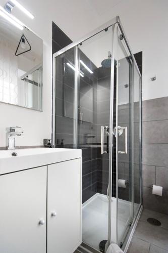 a bathroom with a glass shower and a sink at Mellos B&B in Naples