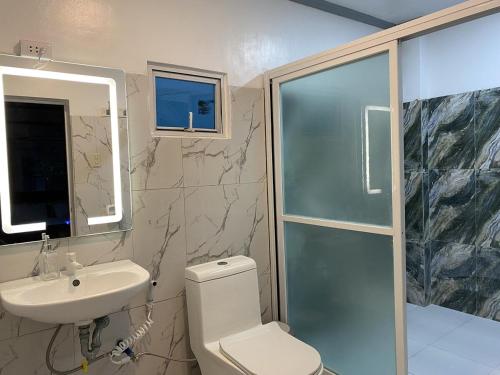 a bathroom with a toilet and a sink and a shower at Beachfront Sunset Getaway in Allen