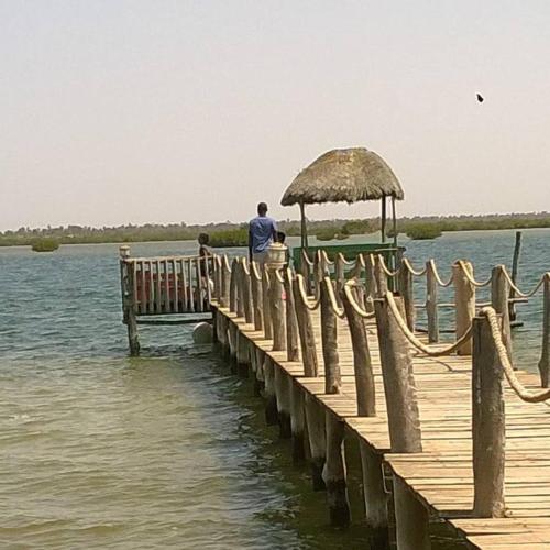 a man standing on a dock in the water at Mar Setal in Mar Lodj