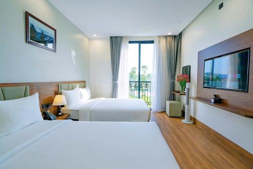 a hotel room with a bed and a television at Thời đại Hotel in Thanh Hóa