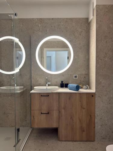 a bathroom with a sink and a mirror at Let's Sea Positive Vibe apartment in Gąski