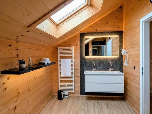 a bathroom with a white sink and a skylight at Chalet Rattendorf 139 in Rattendorf