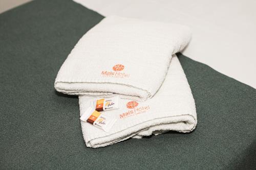 a pile of white towels sitting on a table at Mais Hotel in Araguaína