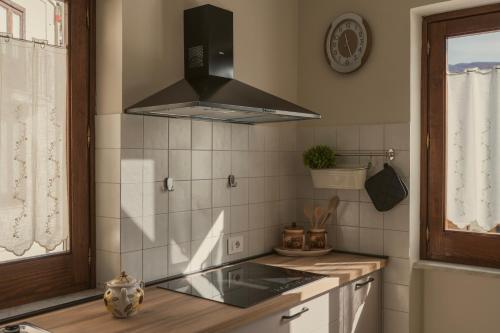 a kitchen with a sink and a stove top oven at Hera Home B&B in Serra Pedace