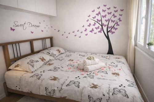 a bedroom with a bed with a tree on it at Mobile House Sweet Dreams - Terme Čatež in Brežice