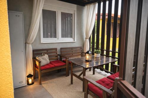 a balcony with a table and benches on a balcony at Mobile House Sweet Dreams - Terme Čatež in Brežice