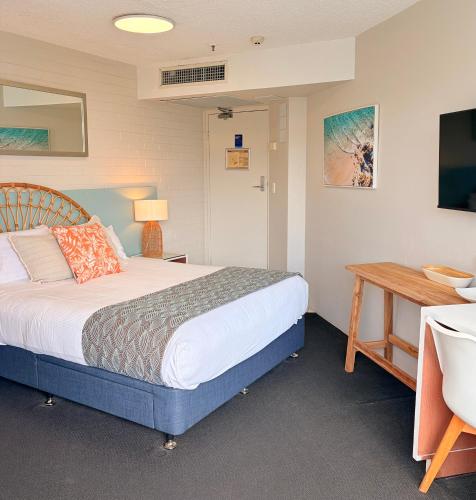 a bedroom with a bed and a table and a desk at Marcoola Surf Air Hotel Room 2515 in Marcoola