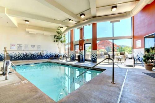 a swimming pool in a hotel lobby with a large window at The Lodge at Roseburg in Roseburg