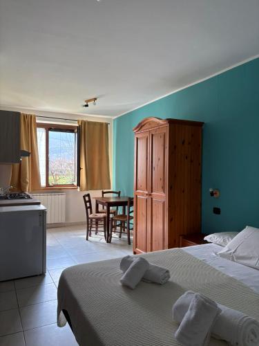 a bedroom with two beds and a dining room with a table at Agriturismo San Giuliano dei fratelli Giai in Susa