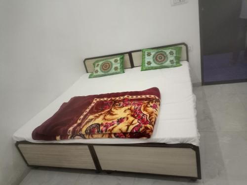 a bed with a pillow and some money on it at Chohan guest house in Khātu