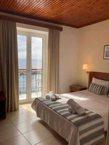 a bedroom with a bed with a view of the ocean at Sea Horse in Mythimna