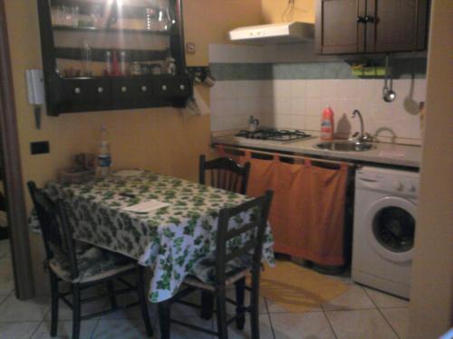 a kitchen with a table and chairs and a stove and a sink at Lina House in Giardini Naxos