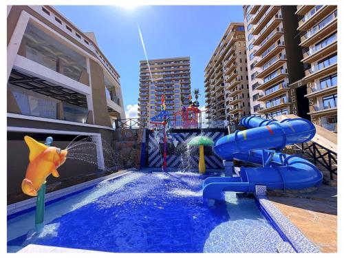 a water park with a pool with a water slide at Tulivu Beach Stays in Jeuri
