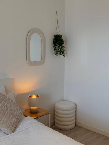 a bedroom with a bed and a table with a lamp at Casa Claude in Menaggio
