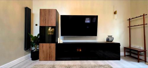 a living room with a large flat screen tv at Dabbagh Residence in Lees