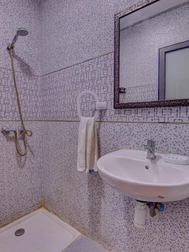 a bathroom with a sink and a mirror at Beach Apartment with Pool Banana Beach Surf Spot in Aourir