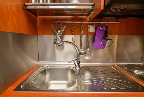 a stainless steel sink in a kitchen with utensils at Villa Andromeda in Amorgos