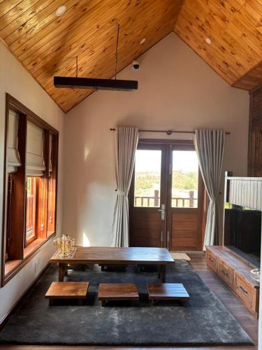 a living room with a wooden table and a tv at R Chai in Countach Da