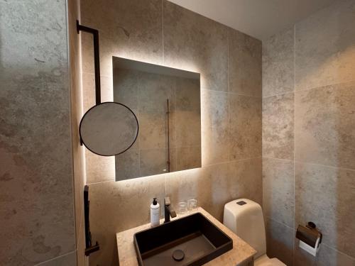 a bathroom with a sink and a mirror at Åh Stifts- & Konferensgård in Ljungskile