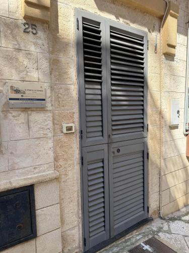 a door on the side of a stone building at Il ponte di vetro Home in Brindisi
