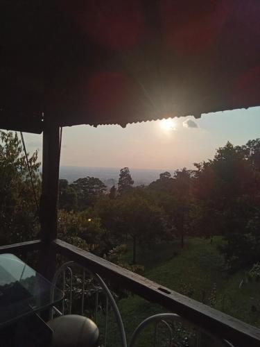 a view of the sunset from the balcony of a house at BUKIT LIMAU REST HOUSE in Taiping