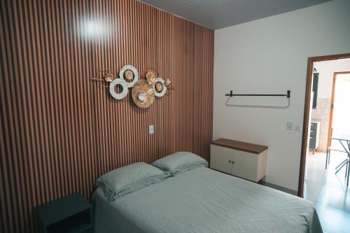 a bedroom with a bed and a red striped wall at Residencial Antônio Floriza in Sinop