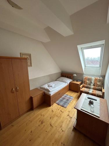 a small bedroom with a bed and a window at Hotel Allvet in Drnovice