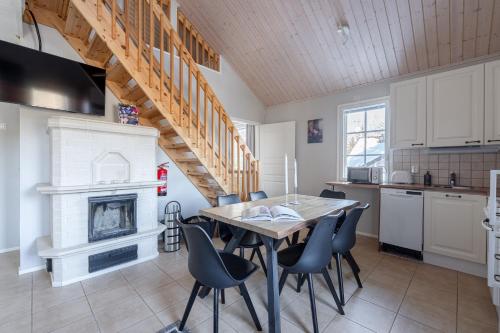 a kitchen and dining room with a table and chairs at Villa Magnolia 1 Himos in Jämsä