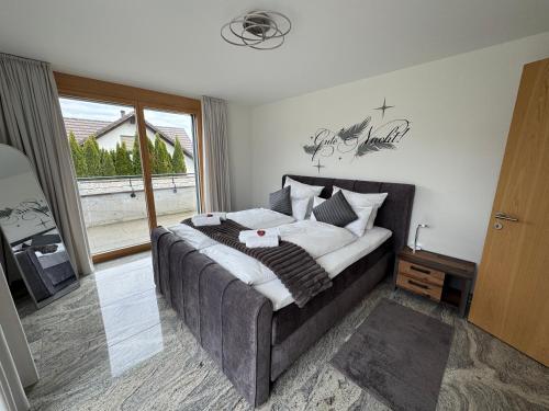 a bedroom with a large bed and a window at Arenenberg-Panorama in Salenstein