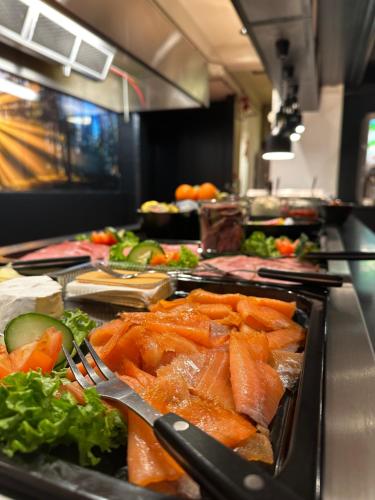 a buffet line with a bunch of food on at Grong Hotell in Grong