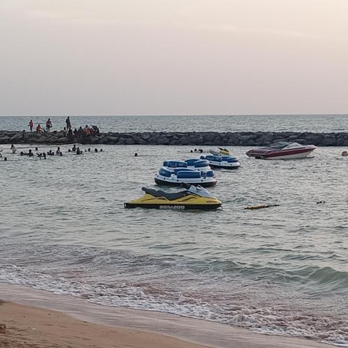 a group of boats in the water at the beach at Appartement Keur Diam Saly in Saly Portudal