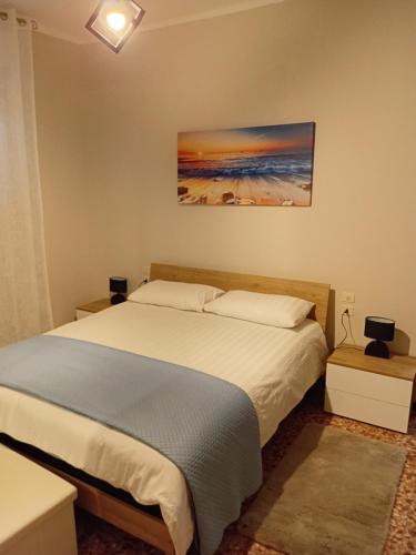 a bedroom with a bed and a painting on the wall at Alloggio Veronica in Voghera