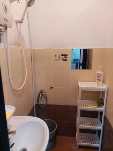 a small bathroom with a sink and a mirror at Abadi Homestay Ipoh in Ipoh