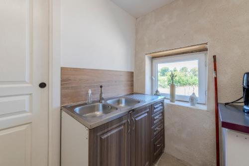 a kitchen with a sink and a window at Yourte mongole insolite en pleine nature in Pouilly-sous-Charlieu