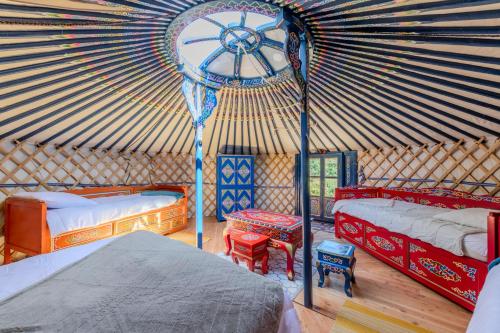 a room with two beds in a yurt at Yourte mongole insolite en pleine nature in Pouilly-sous-Charlieu