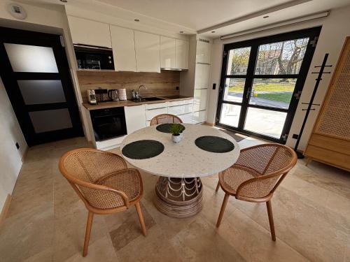 a kitchen with a table and chairs in a room at Logement Seigneur in Rambervillers