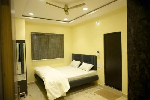 a bedroom with a bed and a window in it at hotel nemi residency jagdalpur in Jagdalpur