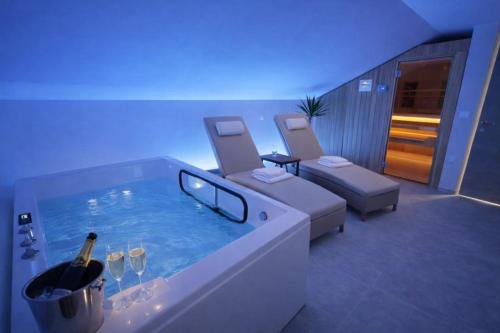 a room with a tub with a bottle of wine in it at Rooms S Center in Slovenske Konjice