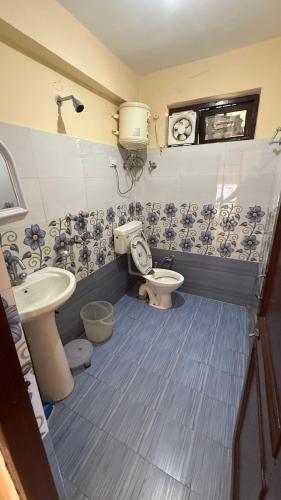 a bathroom with a toilet and a sink at Ghar by the mountains in McLeod Ganj