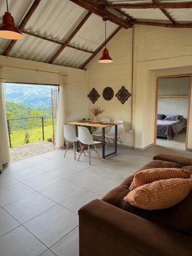 a living room with a couch and a table at La Morada Quindio cabaña campestre in Boquía