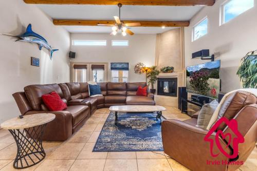 a living room with a couch and a table at Desert Hills - An Irvie Home in Albuquerque